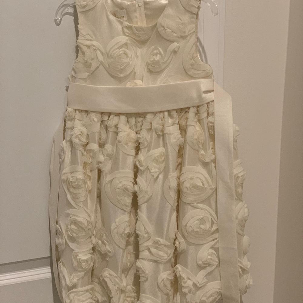 Beautiful cream dress with flower detail.